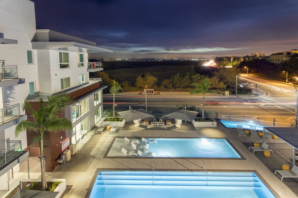 an aerial view of a pool in a hotel at night